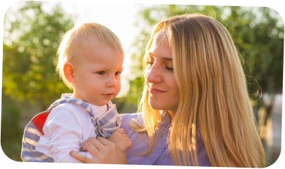 Au Pair holding child in sunshine-1