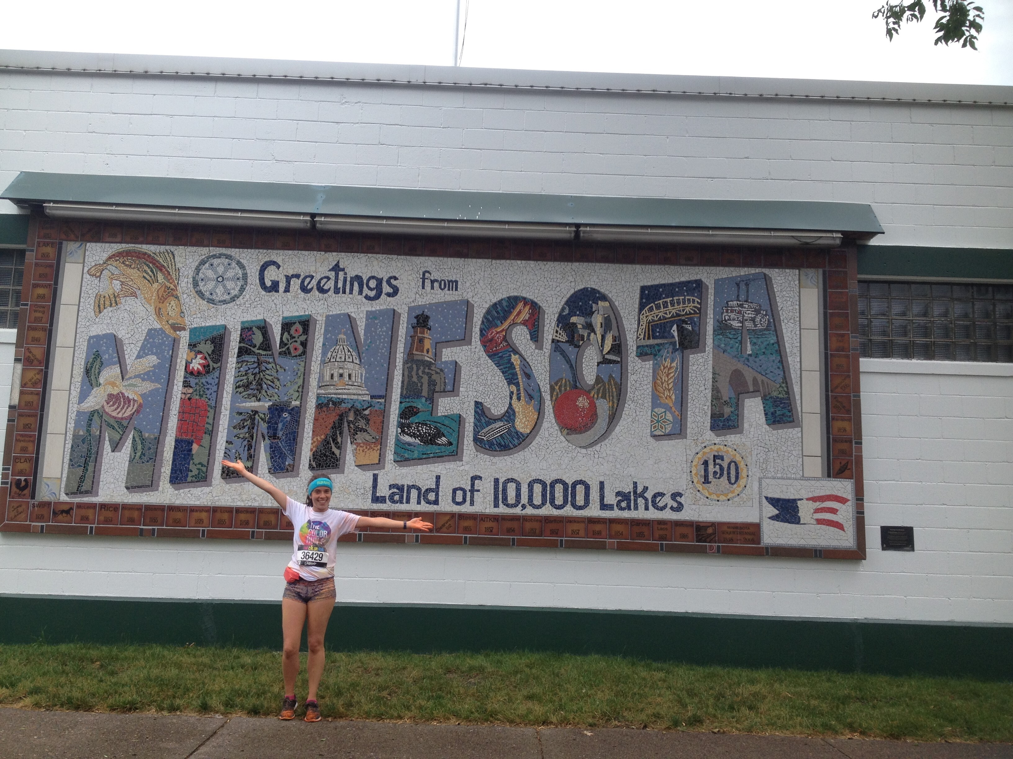 Maria stood in front of a huge "Welcome to Minnesota" sign