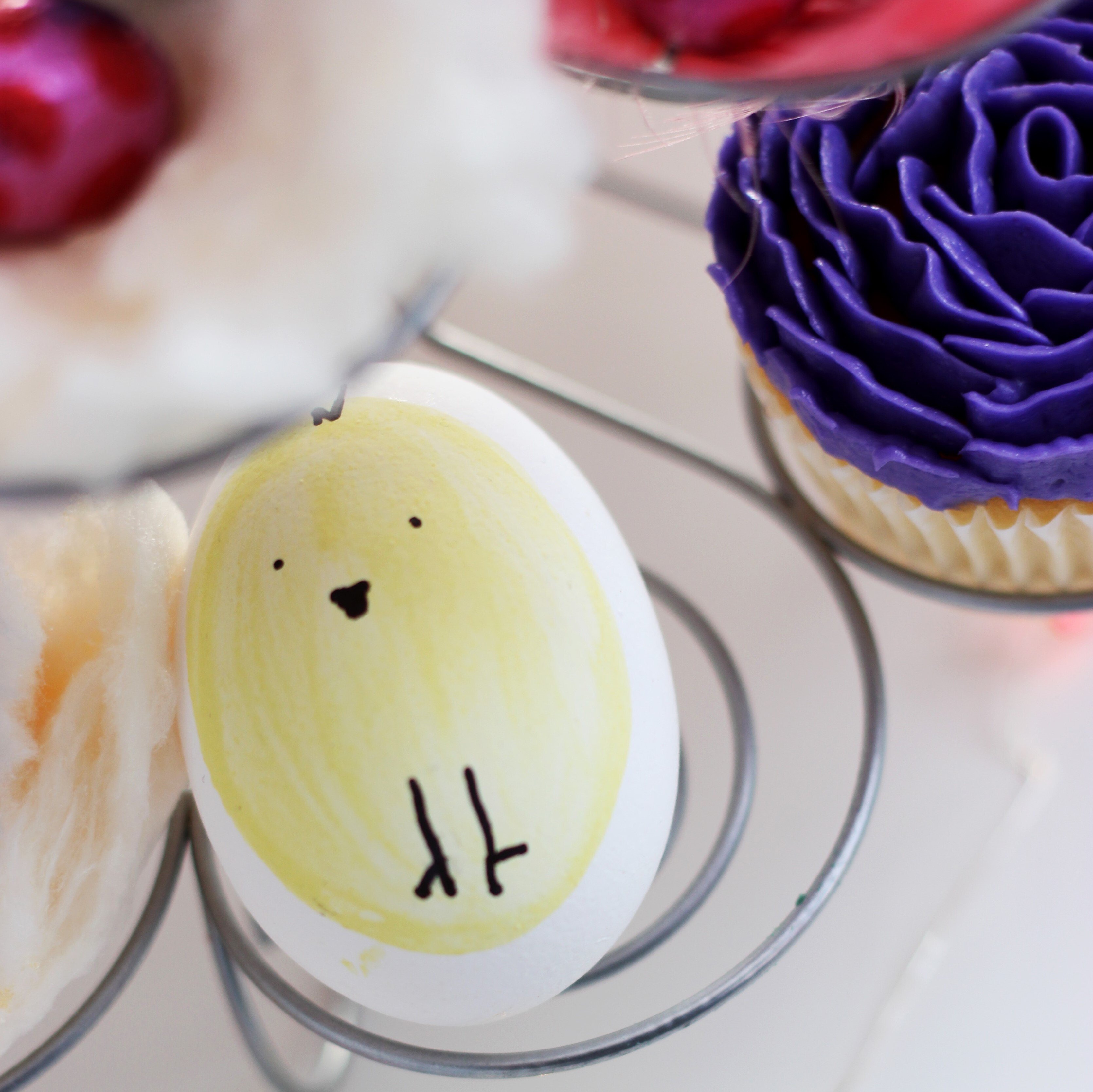 An egg with a chicken painted on it.
