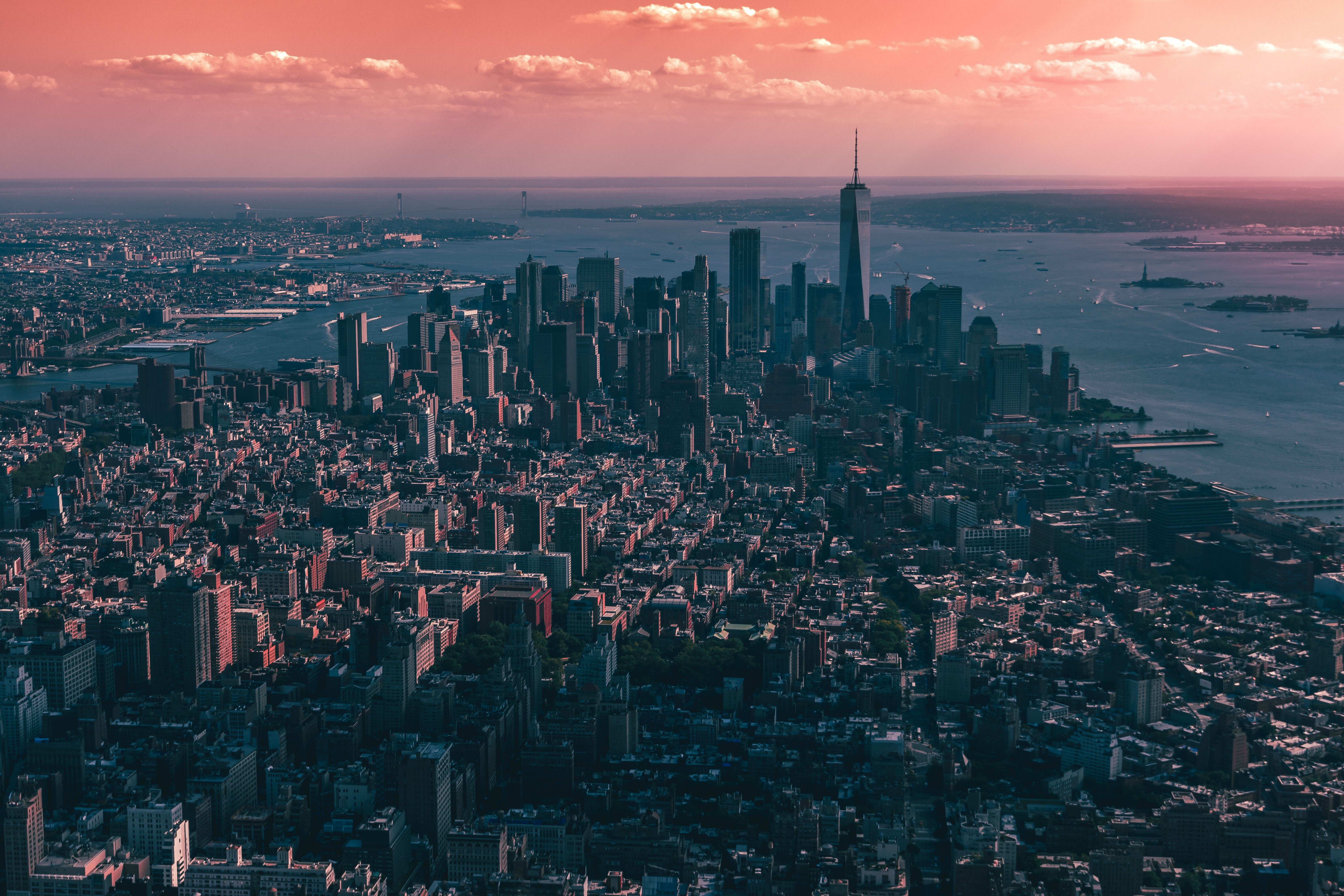 New York City's skyline at dusk, with a pink sky.