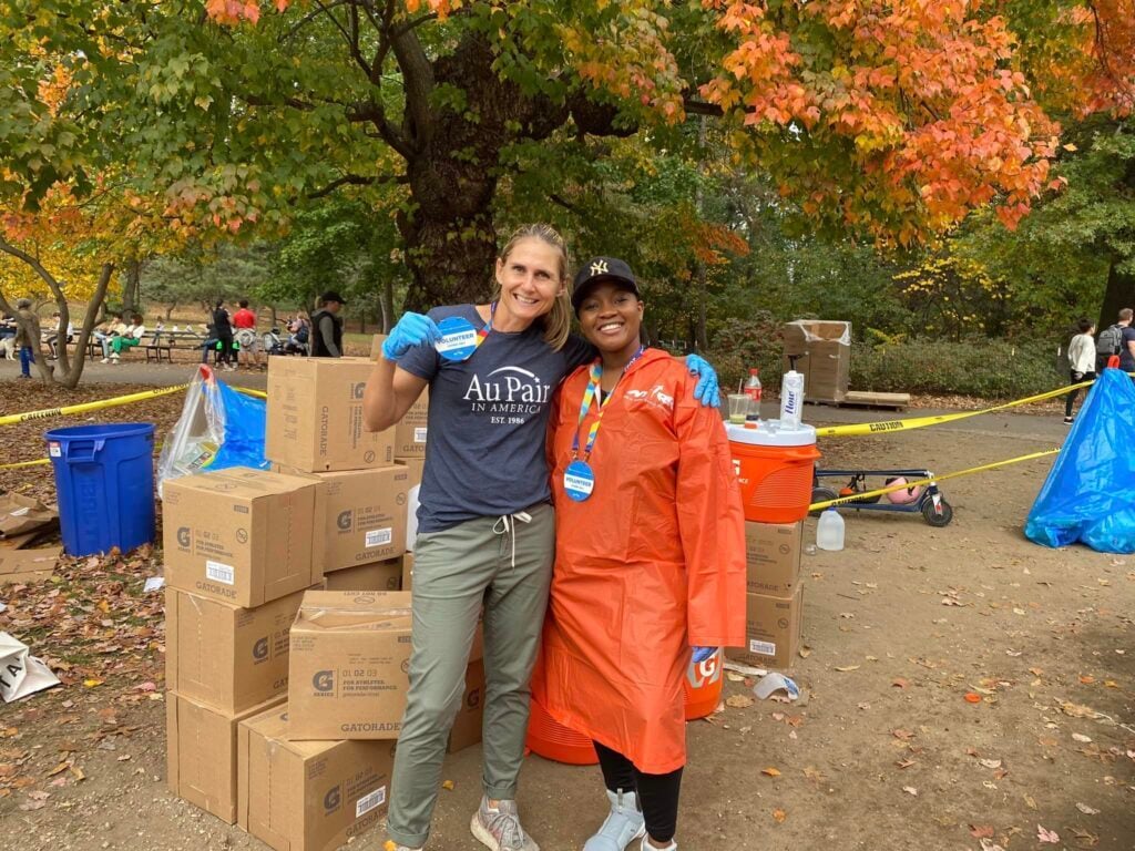 Volunteering, handing out refreshments at a marathon.