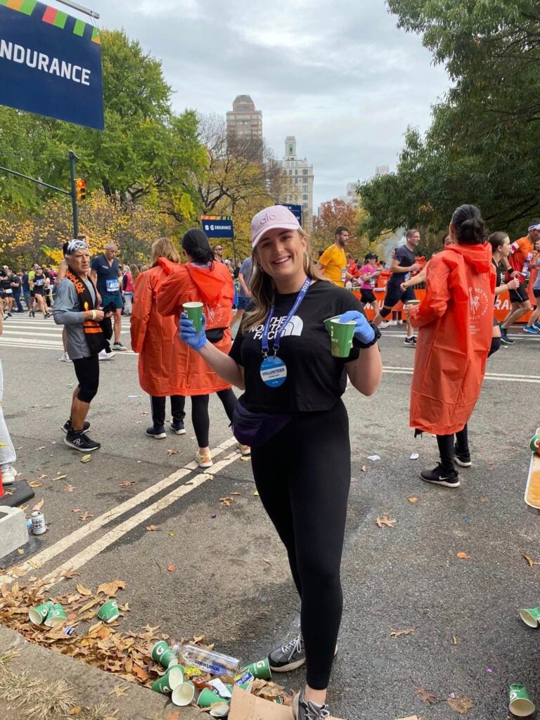 Volunteering, handing out refreshments at a marathon.