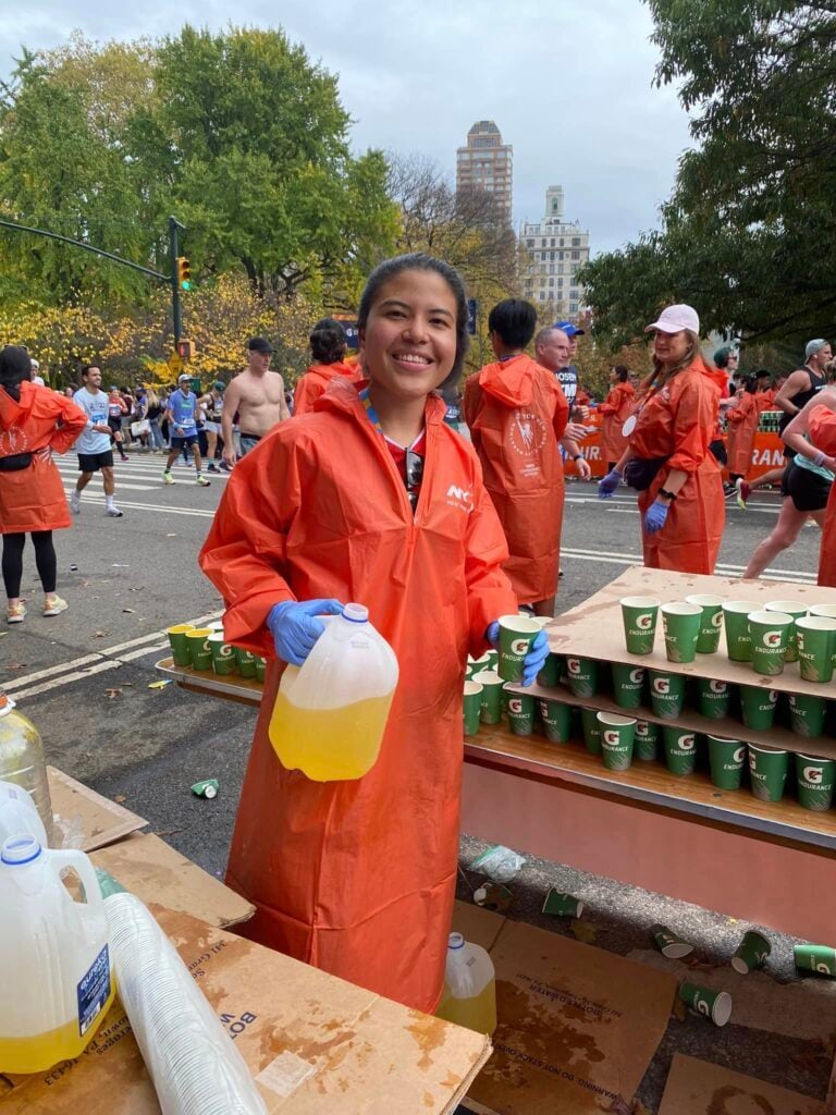 Volunteering, handing out refreshments at a marathon.
