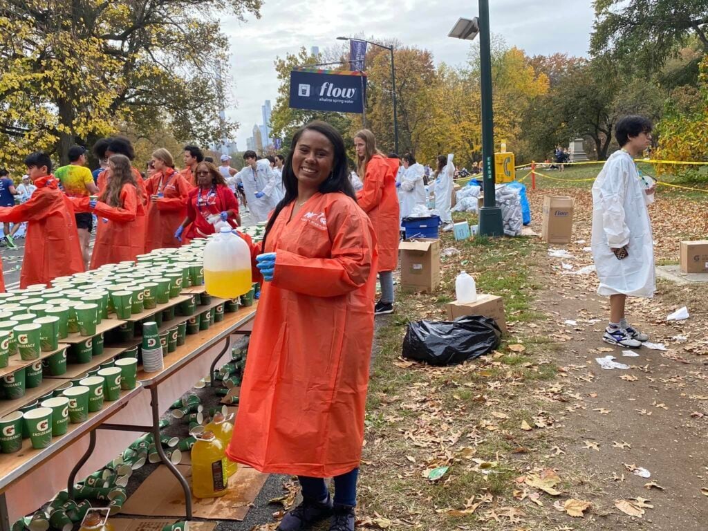 Volunteering, handing out refreshments at a marathon.